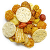 The Sumatra Rice Crackers offer an assortment of savory vegetarian snacks, featuring a variety of round, oval, and textured pieces. Some are seasoned while others are plain, all arranged randomly on a white background.