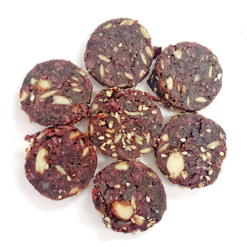 Prunes & Cinnamon Bites with sesame seeds on a white background.