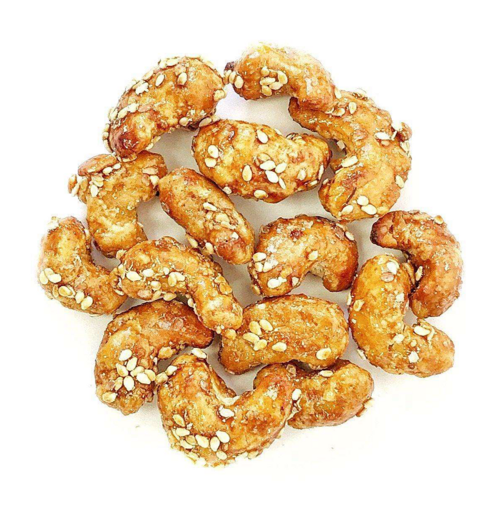 Honey Sesame Cashews, enriched with non-dairy calcium and sprinkled with sesame seeds, beautifully arranged in a circle on a white background.