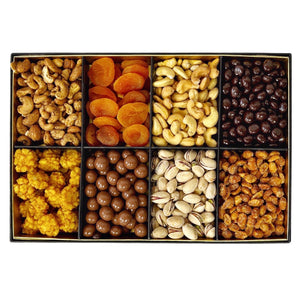 A curated assortment of The Supreme Nuts Gift Selection and dried fruits elegantly presented in a sleek black gift box, set against a pristine white backdrop.
