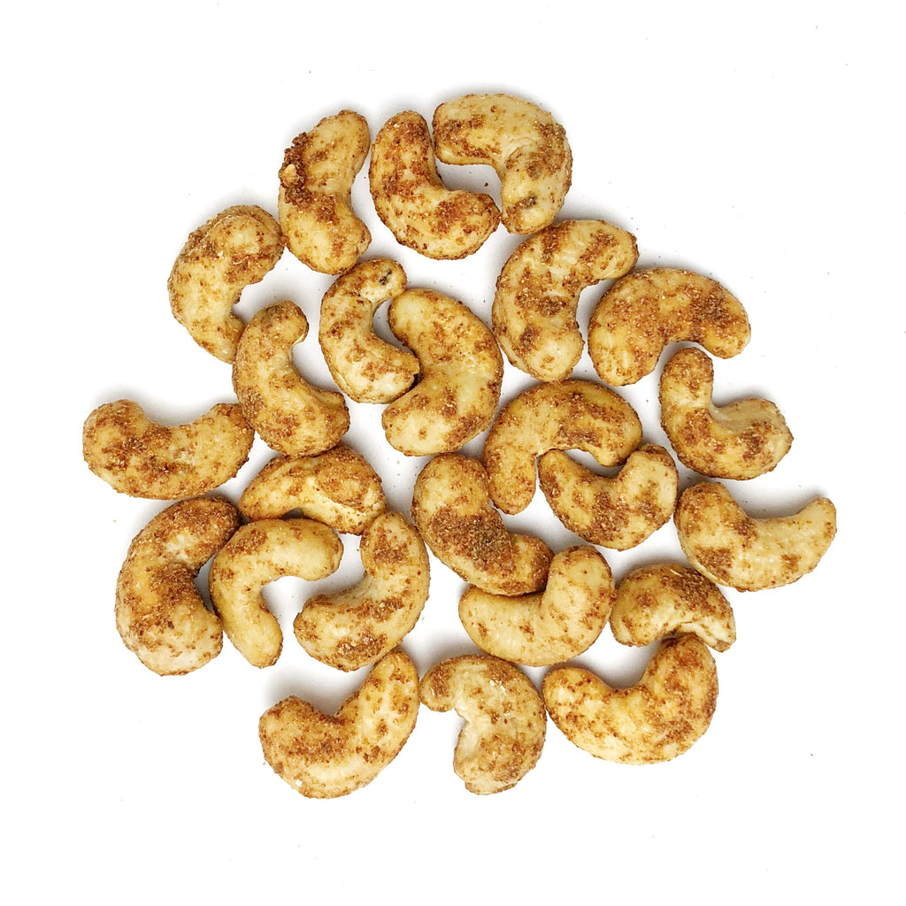 Close-up of a pile of Masala Flavoured Cashew against a white background.