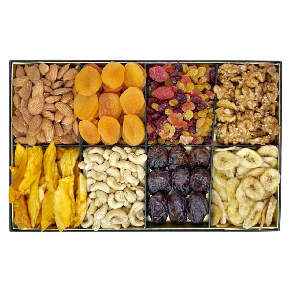 The Nuts & Fruits product is a rectangular box featuring eight compartments filled with a healthy assortment of almonds, dried apricots, mixed dried fruits, walnuts, dried mango, cashews, dates, and banana chips.