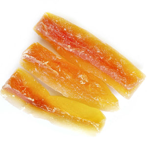 Three slices of dried papaya on a white background.